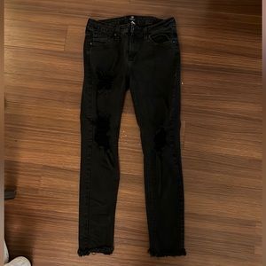 JUST BLACK JEANS WITH RIPS DOWN THE LEG